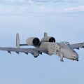 Military Fighter Jet Flying High in Blue Sky with White Clouds