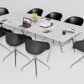 Modern Conference Table With White Top Black Chairs Laptop Flower Vase Coffee Mug And Documents