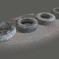 Four Old Worn Tires Placed On Gray Rough Ground Surface 3d model