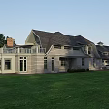 Detached House Exterior With Green Lawn Curved Gravel Driveway And Swimming Pool