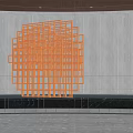 Modern Orange Geometric Lattice Sculpture with Reflection in Circular Pool and Gray Wall