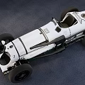 Vintage White Race Car With Open Design And Exposed Mechanical Parts On Gray Surface