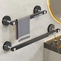 Black Bathroom Towel Rack With Gray Towel On Tiled Wall And Round Mirror