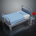 Hospital Medical Bed With Blue Mattress Safety Rails And Side Table