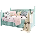 Light Blue Baby Crib With Soft Pink Polka Dot Blanket And Decorative Pillows