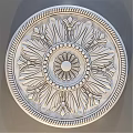Decorative Circular Component With Intricate Carved Flower And Leaf Patterns And Beaded Border Design