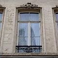 Vintage Building Window With Cracked Facade Iron Railing And Sheer Curtains