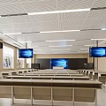Spacious School Classroom With Long Desks Chairs Multiple Screens Wooden Walls And Bright Lighting