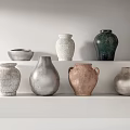 Ceramic Vessels In Various Colors And Shapes On White Minimalist Shelf