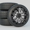 Car Tire with Black Geometric Alloy Wheel and Tread Pattern Design
