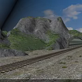 Railway Track Leading To Mountain Tunnel With Green Hills And Blue Sky