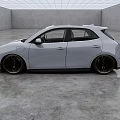 White Compact Electric Vehicle With Modern Design And Black Wheels In Indoor Showroom