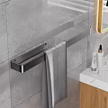 Modern Bathroom Accessory Arrangement With Metal Towel Rack Gray Towel Marble Countertop And Skincare Products