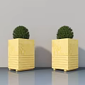 Yellow Wooden Square Planters Holding Green Spherical Potted Plants With Striped Design And Wheels Indoor Decor