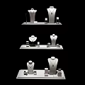 Jewelry Showcase On White Display Stands With Necklace Mannequins And Small Accessories