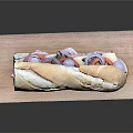 Fresh Long Loaf Bread On Wooden Cutting Board With Golden Crust