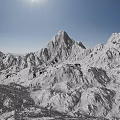 Snowy Mountain Terrain With Tall Snow-Covered Peaks Clear Blue Sky And Bright Sun