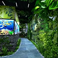 Lush Green Plant Decor With Tree Branch Archway And Large Aquarium Featuring Colorful Fish