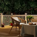 Scenic Evening Patio Landscape With White Railings Wicker Furniture Flower Vase And Trees