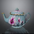 Blue Teapot With Pink Floral Patterns And Gold Accents On Lid And Handle