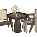 Round Wooden Table and Woven Chair Set with Floral Vase Bread and Light Blanket