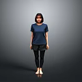 A Woman Standing Barefoot in Blue T-Shirt and Black Pants Against Gray Background