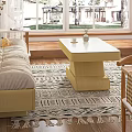 Beige Two-Seater Sofa with Orange and Checkered Pillows in Modern Living Room with Coffee Table