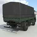 Green Military Transport Truck With Canvas Covered Cargo Area And Cab
