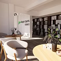 Modern Public Office Space Interior With Desks Computers Bookshelf Pendant Lights And Wooden Flooring