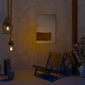 Earthy Toned Ceramic Vessels Of Various Shapes With Hanging Lanterns Wall Art And Chair