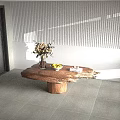 Natural Edge Wooden Coffee Table With Flower Vase Bowl of Fruits and Stack of Books