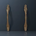 Elegant Golden Door Handles With Curved Metal Design And Shiny Finish