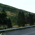 Swing Doors With Green Mountain Vegetation And Roadside Guardrail View