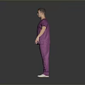 Man in Purple Scrubs Standing on Gray Background with Arms at Sides