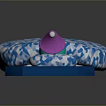 Blue Cushion Featuring White Geometric Pattern And Small Doll With Pink Hat