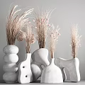 White Ceramic Vases With Various Shapes Holding Dried Pampas Grass And Pink Blossoms