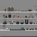 Various Traditional Ceramic Tea Sets Displayed On Shelves With Decorative Ornaments