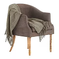 Gray Armchair With Black And White Herringbone Blanket And Wooden Legs