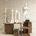 Clothing Store Featuring White Dresses Tops Mannequin Wooden Display Tables Green Plant And Shoes