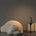 White Polar Bear Shaped Bean Bag Chair With Small Table Metal Sculpture And Open Book
