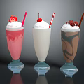 Pink White And Chocolate Milkshakes With Fresh Fruit And Chocolate Shavings In Glass Cups