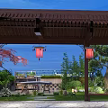 Chinese Garden Landscape with Wooden Pavilion Red Lanterns Green Trees Stone Path and Blue Sky