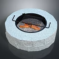 Outdoor Circular Stone Fire Pit With Burning Wood And Metal Grill