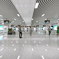 Modern Spacious Bright Station Hall With Multiple Screens And Pedestrians Walking