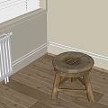 Wooden Stool With Round Worn Seat Crossed Legs Near White Radiator On Wooden Floor