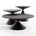Three Black Round Coffee Tables With Conical Bases And Modern Minimalist Design