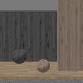Two Decorative Spheres On Wooden Floor With Textured Wall And Warm Lighting