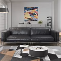 Black Leather Three Seater Sofa With Metal Legs In Modern Living Room With Abstract Art