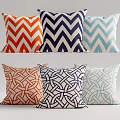 Decorative Throw Pillows with Chevron and Interlaced Patterns in Orange Blue and White Tones 3d model