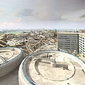 Large Circular Concrete Structures Amid Collapsed Building Ruins With Distant Multi Story Building